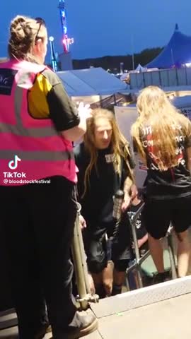 Security tries to stop a guy walking backstage, not realising its the lead vocalist, Randy Blythe
