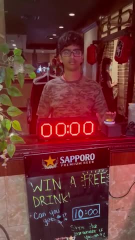 Winning a free beer by stopping the timer at exactly 10 seconds
