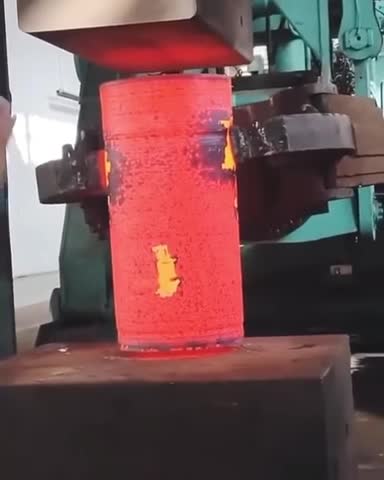 Compressing hot metal with hydraulic press...